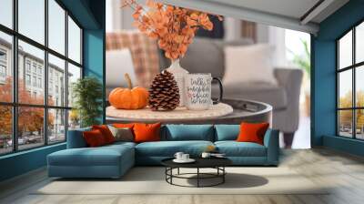 Coffee table with a mug that says Talk Pumpkin Spice to Me in a stylish living room decorated for fall Wall mural