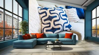 Closeup of new modern blue couch sofa by windows with natural light and pillows Wall mural