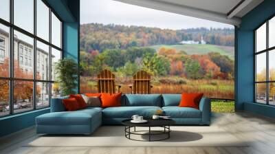 Empty wooden chairs in autumn fall foliage season countryside at Charlottesville winery vineyard in blue ridge mountains of Virginia with cloudy sky day Wall mural