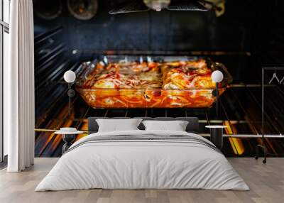 Inside oven with rack and homemade Mexican food enchiladas in baking tray glass dish cooking with tomato sauce, tortilla and cheese Wall mural