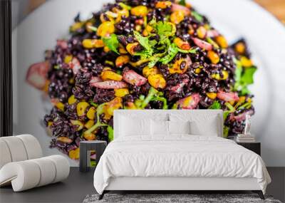 Macro closeup of forbidden Chinese black rice dish with corn, vegetables, onions, cilantro on plate isolated Wall mural