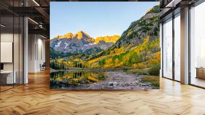 Maroon Bells lake at sunrise sunlight in Aspen, Colorado with rocky mountain peak and snow in October autumn and golden fall leaf color trees reflection on water Wall mural