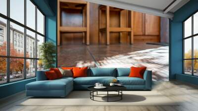 Modern kitchen room tiled floor low angle closeup with island and wooden bar stools at counter in house or apartment with sunlight from window Wall mural