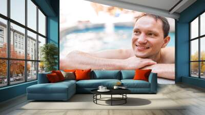 young man happy face swimming in japanese spa in japan onsen hot spring pool with bokeh background b Wall mural