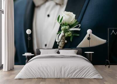 Smartly dressed person at wedding wearing a suit and a coordinating bow tie with flowers in a pocket Wall mural