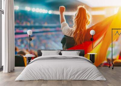 Young woman fan stands in stadium, arms raised high, holding Germany flag, embodying national pride and sports enthusiasm under sunset skies of eventful game day. Concept of sport competitions Wall mural