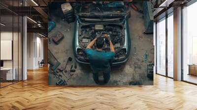 mechanical man working with tools and spanner. Hispanic latin male mechanic repairs car in garage. Car maintenance and auto service garage concept top view Wall mural