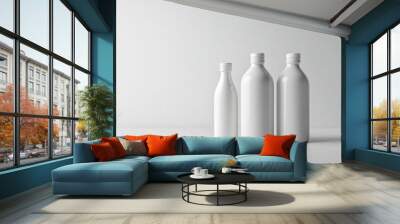 Three white bottles on a white surface. Wall mural