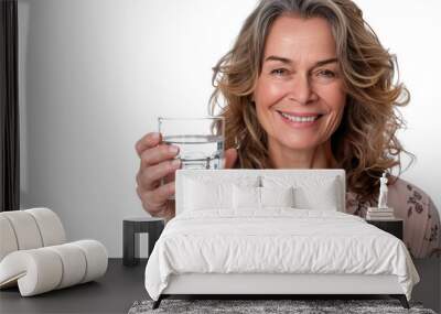 Woman smiling, drinking water outdoors. Wearing white and brown clothing. Natural setting with focus on her face and the beverage isolated on white background Wall mural