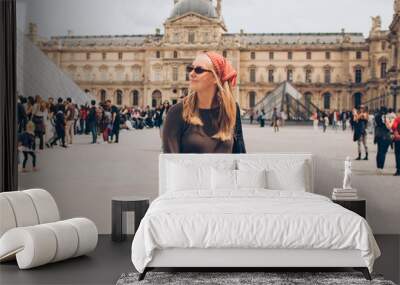 woman tourist wearing a red kerchief and sunglasses at the louvre in paris Wall mural