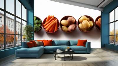 a row of bowls with various types of vegetables including carrots potatoes Wall mural