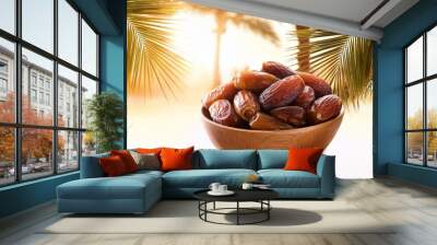 dates in a wooden bowl under palm trees Wall mural