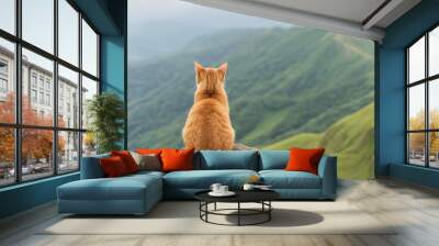 An orange cat gazes over a lush green mountain landscape, enjoying nature's beauty in peaceful solitude. Wall mural