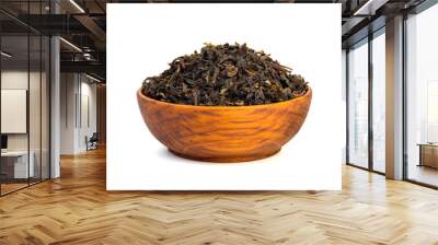 Dried tea leaves in wooden teak bowl isolated on white background. Wall mural