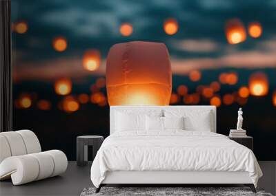 Crowd releasing paper lanterns into the night sky, glowing and festive. Wall mural