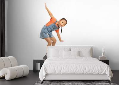 Happy Asian little girl child play surf skate board, isolate on white background. Wall mural