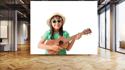 Happy smiling asian little girl were hat and sunglasses playing Ukulele exuding fun. Isolated on white background Wall mural