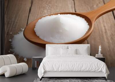 Mound of pure, granulated white sugar nestled in the worn, wooden bowl of a kitchen spoon Wall mural