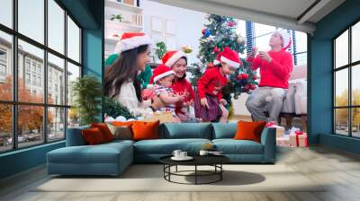 A man and a woman celebrate Christmas with their family. Wall mural