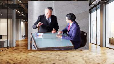 Businessman sitting at desk, businessman concept. Wall mural