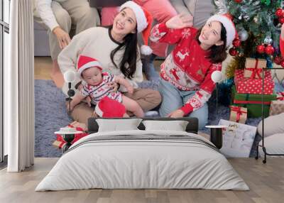 Young woman and family celebrate Christmas. Wall mural