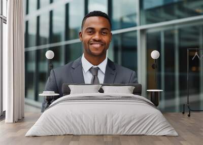 Portrait of a mid adult African American businessman in front of a modern corporate glass building Wall mural