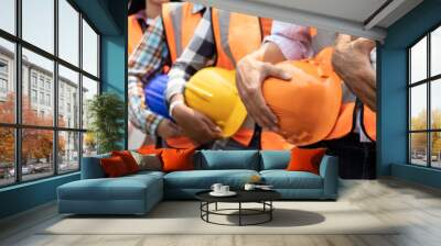 Teamwork of diversity engineer holding helmet standing in row on site work at train garage, banner cover digital design. Wall mural