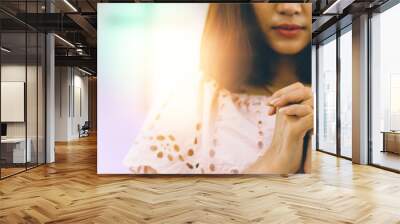 Beautiful asia woman praying inside a church to god  blessing to wishing have a better life. Wall mural