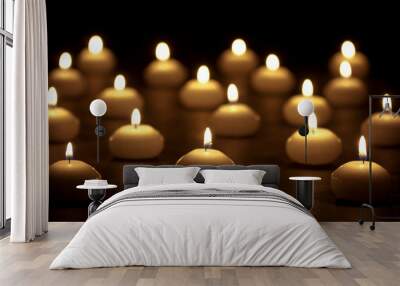 Group of burning candles at a black background with selective fo Wall mural