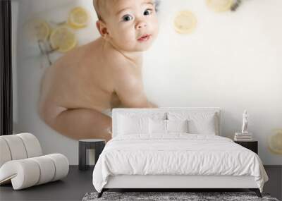 baby child in milk bath with lemons Wall mural