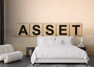 Word ASSET on wooden cubes on yellow background Wall mural