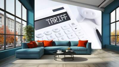 Word TARIFF on calculator. Business concept on white background. Top view. Wall mural