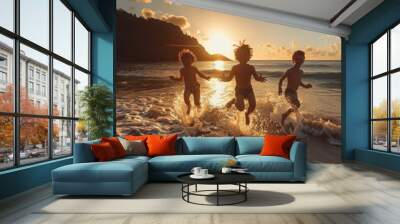 Three children playing and running in the surf of a beach at sunset, backlit by golden sunlight, with a scenic coastline in the background. Concept of carefree childhood and summer fun Wall mural