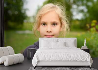 portrait of a cute little six year old european girl on the background of nature outdoor Wall mural