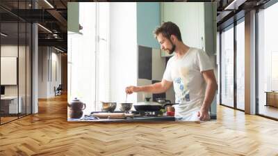 A man at home is cooking Wall mural