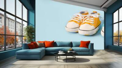 Baby's little shoes on a colorful background. The concept of waiting for a baby and the concept of traveling with baby, children's lifestyle. Copy space, flat lay Wall mural