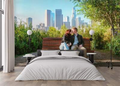 Romantic date of young men and women in the early morning on a park bench overlooking the skyscrapers of Downtown Los Angeles Wall mural