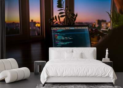 The code is on a laptop on a wooden table in front of the window  in the dark with a view of the lights of the night city, color lighting in the room, home decor	 Wall mural