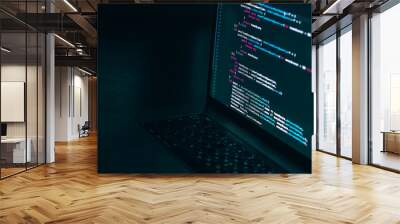 The code on the laptop screen at night. The concept of the SWIFT programming language. Software development. Wall mural