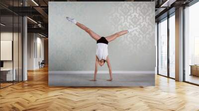 Little ballet caucasian boy dancing in a studio in white shirt and black underpants ballet uniform. Full-length portrait. Wall mural