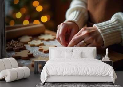 Close-up of woman's hands making cookies from New Year's molds. Against the background of a rustic kitchen. Flickering garlands against the background of the Christmas tree. Cookies in the shape of Ch Wall mural