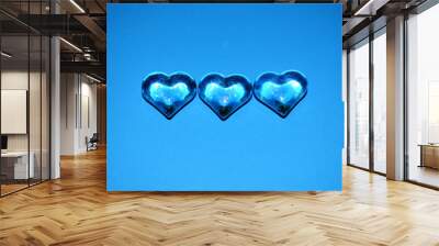 Three hearts on a blue background. Valentine's day. Wall mural