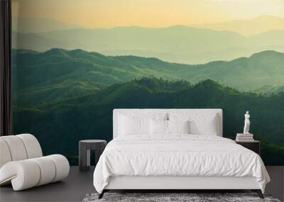 beautiful huge green mountain range shillouete in sunset time with fog Wall mural