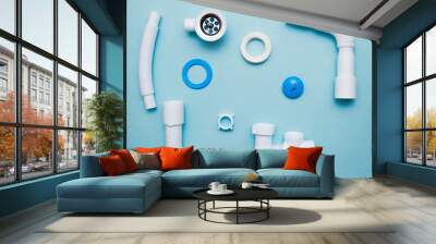 White plastic fittings for plumbing on a blue background Wall mural