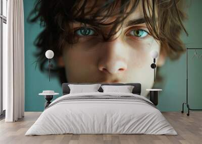 Close-up portrait of a young guy with blue eyes and beautiful lips Wall mural