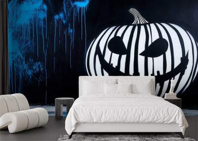 Creepy pumpkin is on a cool blue and black background Wall mural