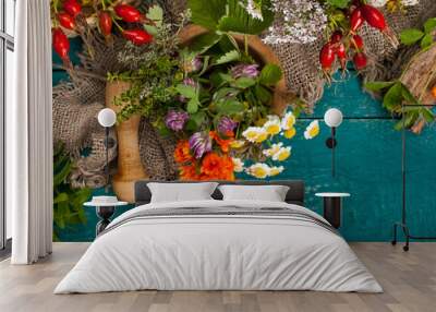 Summer fresh medicinal herbs on the wooden background. Wall mural