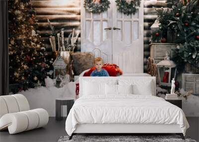 Beautiful little boy on Christmas decor background. Happy Christmas and new year concept Wall mural