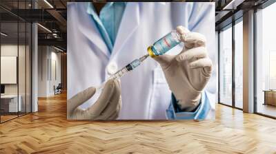 Doctor or scientist filling a syringe with liquid vaccines booster. fight against virus covid-19 coronavirus, Vaccination and immunization. diseases,medical care,science, vaccine booster concept. Wall mural