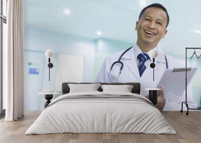 Asian male doctor with a happy smile Wall mural